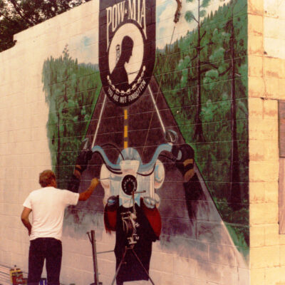 historical photo of Man painting the POW MIA wall