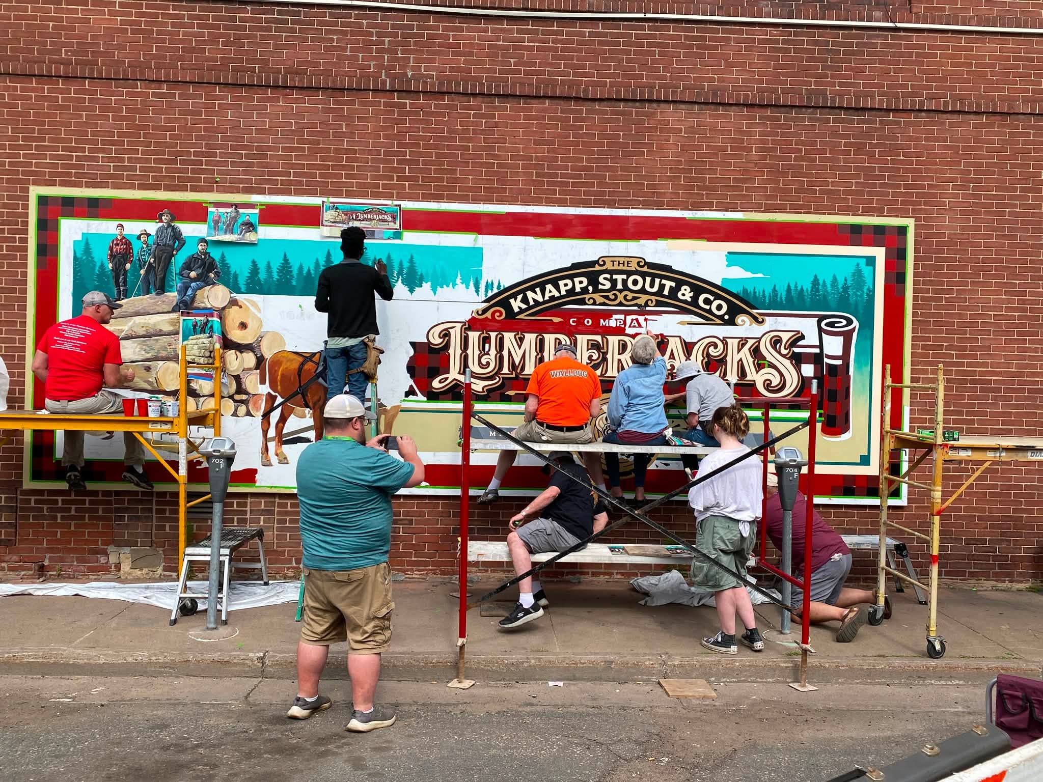 Many artists painting the Lumberjacks mural