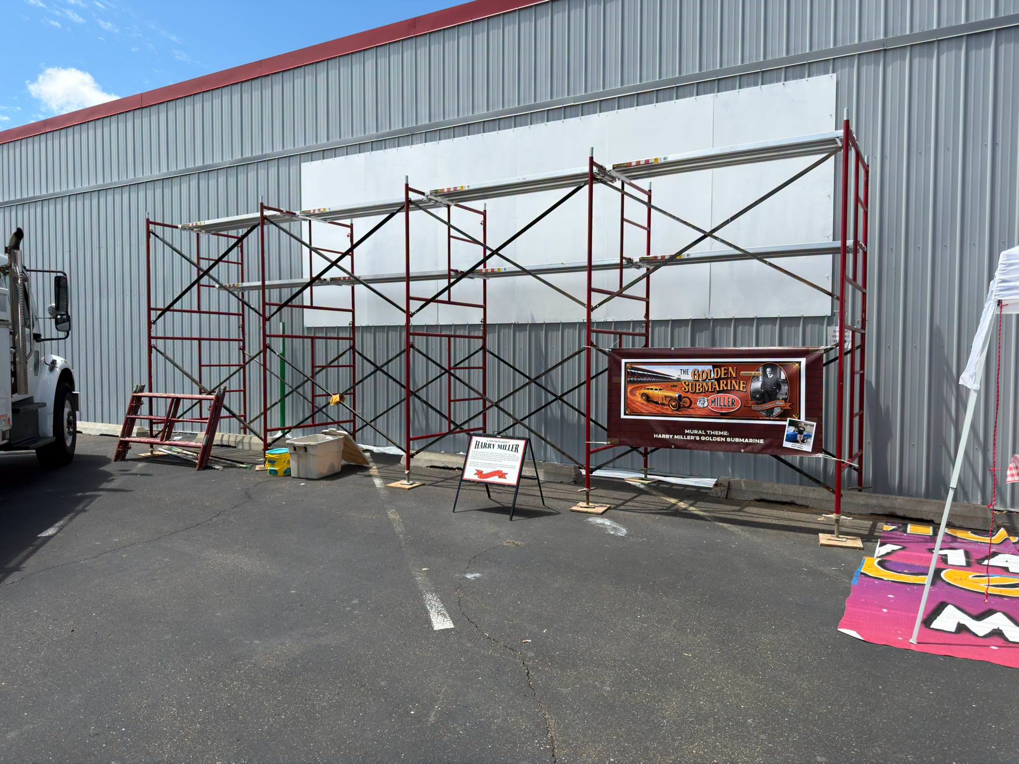 Scaffolding set up in front of a blank white wall