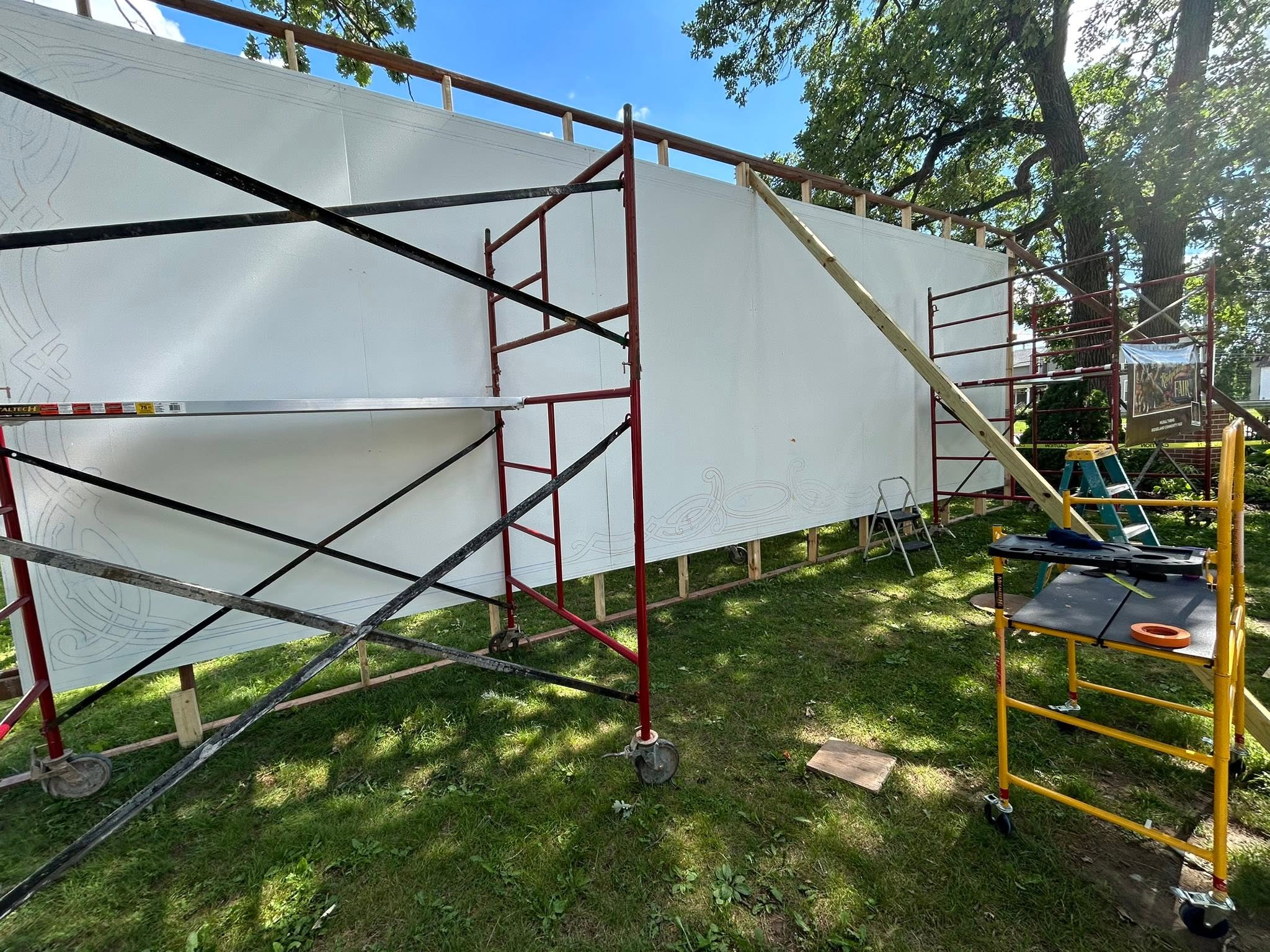 Scaffolding assembled in front of a blank billboard