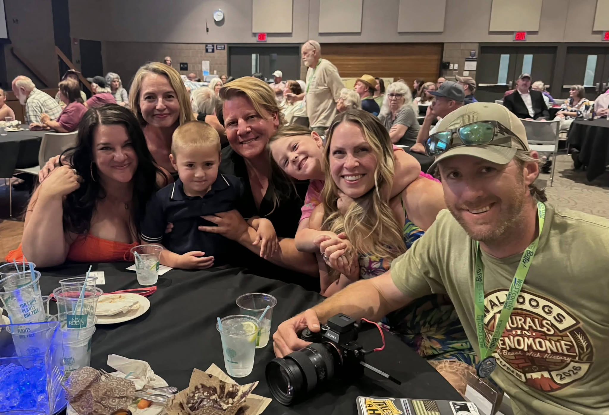 Group of people seated at a table smiling at the camera