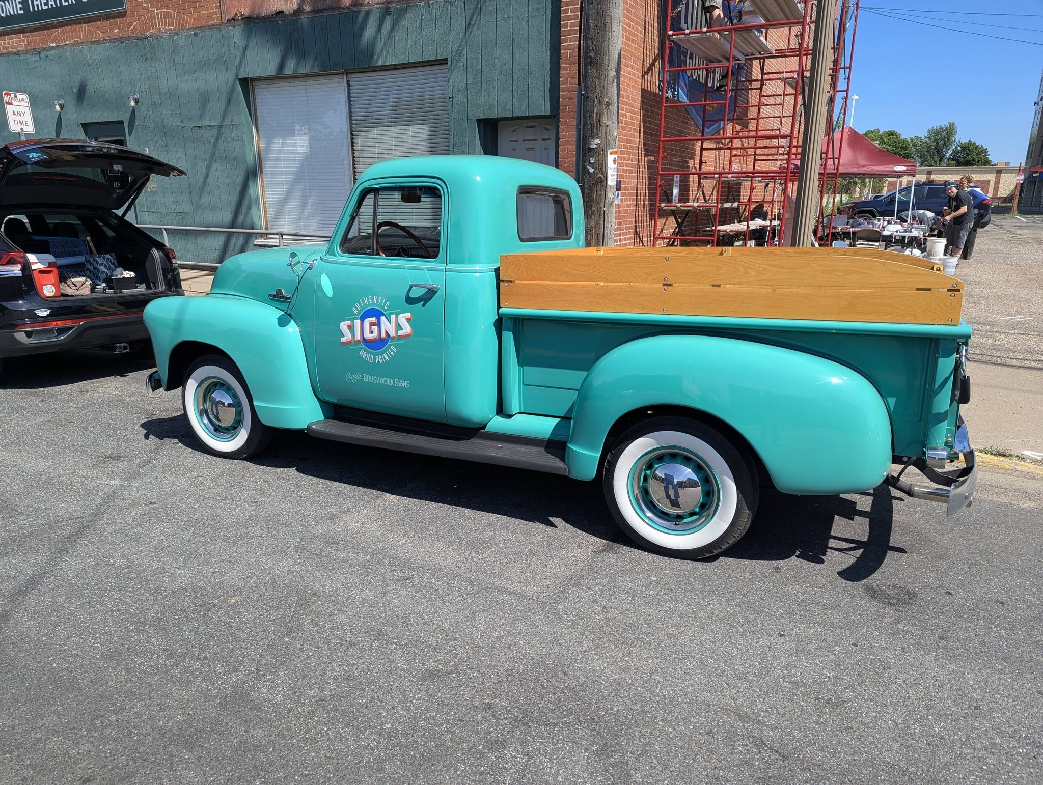 Old fashioned teal truck with wood side panels on truck bed
