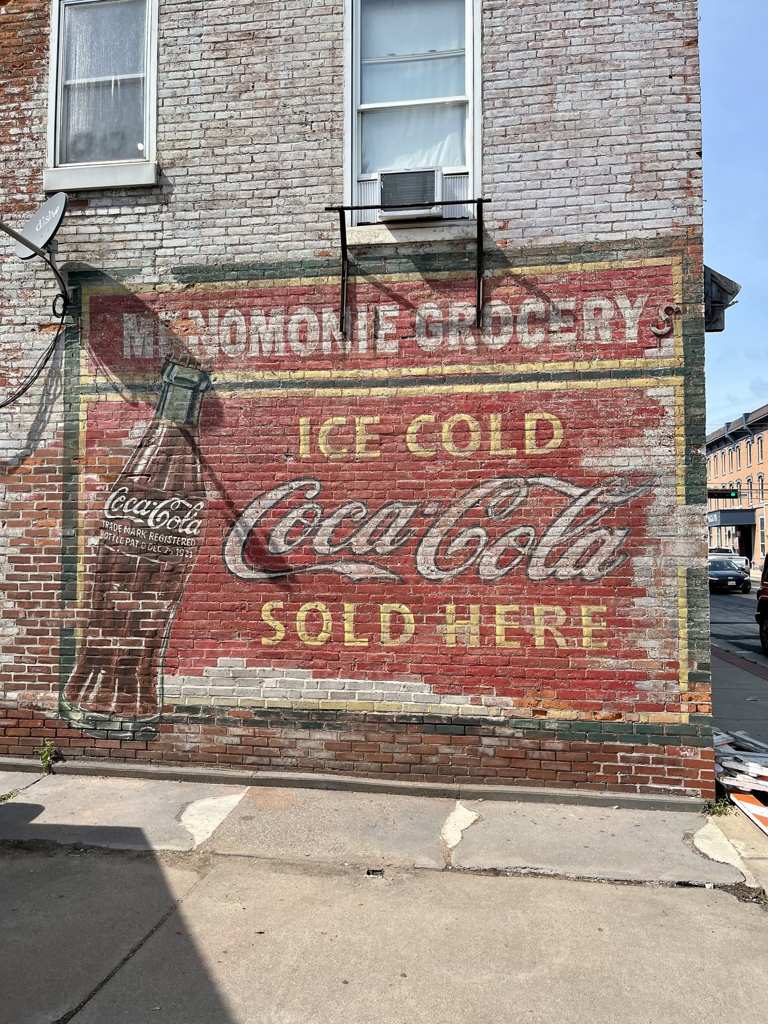 Old vintage painted mural on a brick building - Menomonie Grocery - Ice Cold Coca Cola Sold Here