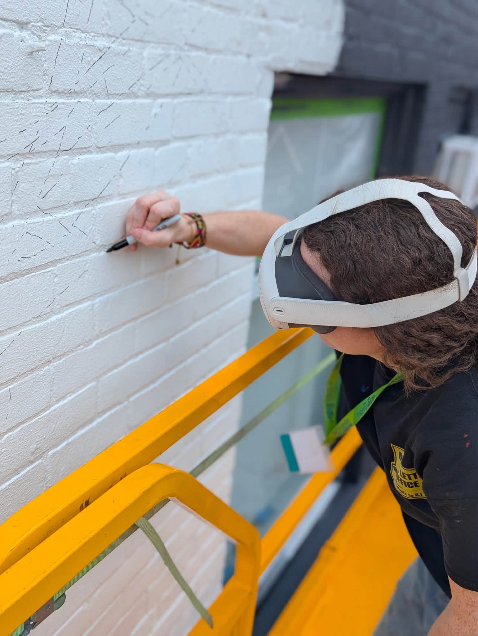 Artist with Meta goggles drawing on wall