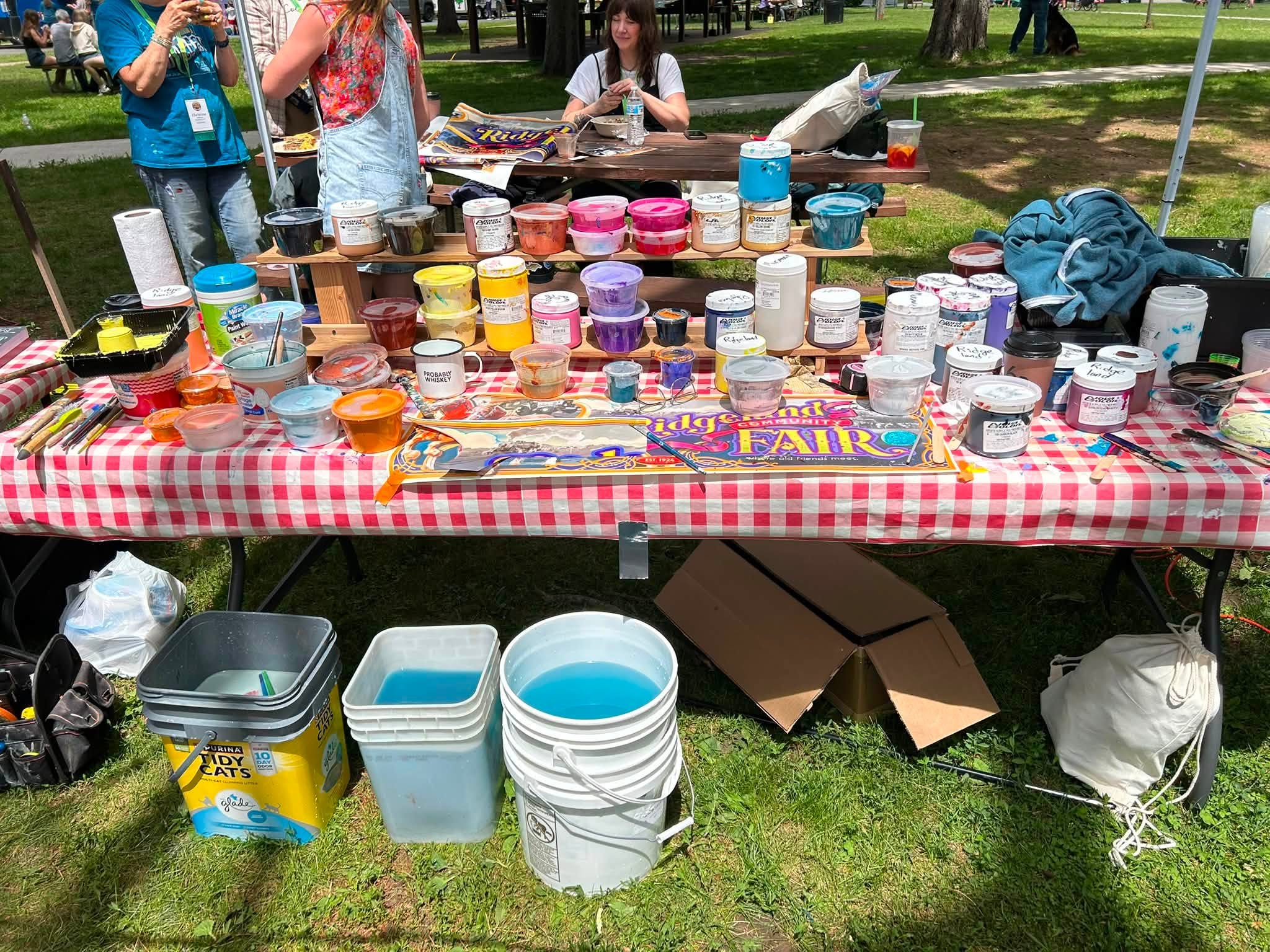 Table filled with canisters of paint
