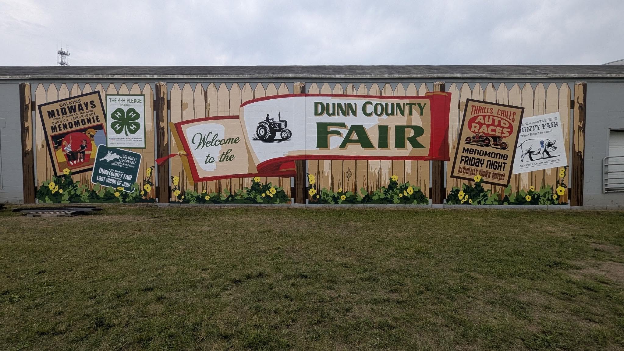 Dunn County Fair Mural complete to look like a fence with signs on it
