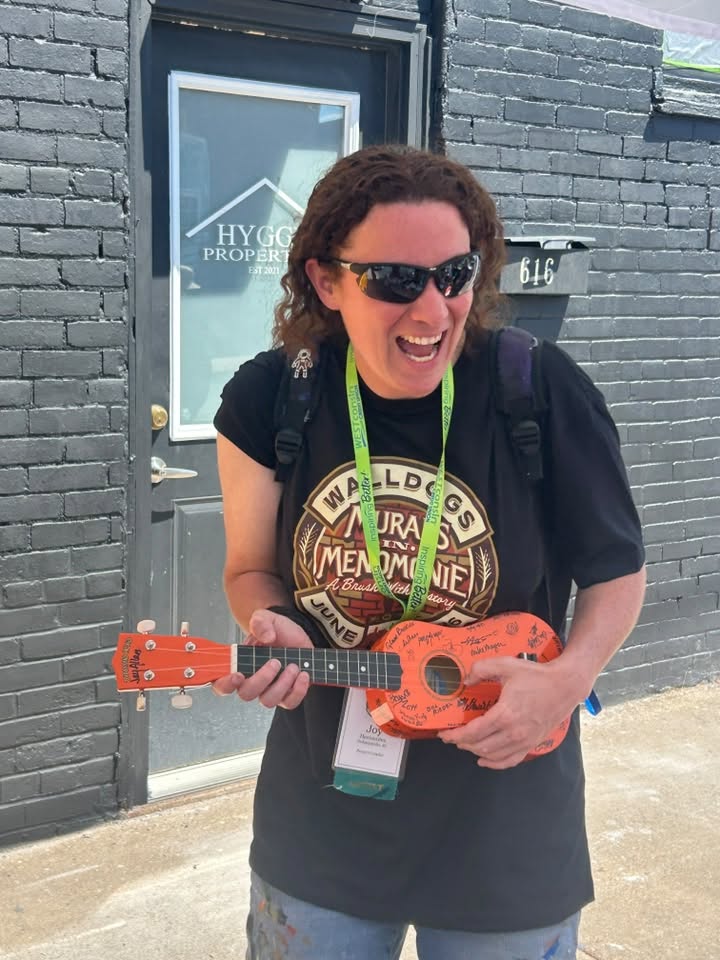 Person playing a ukulele