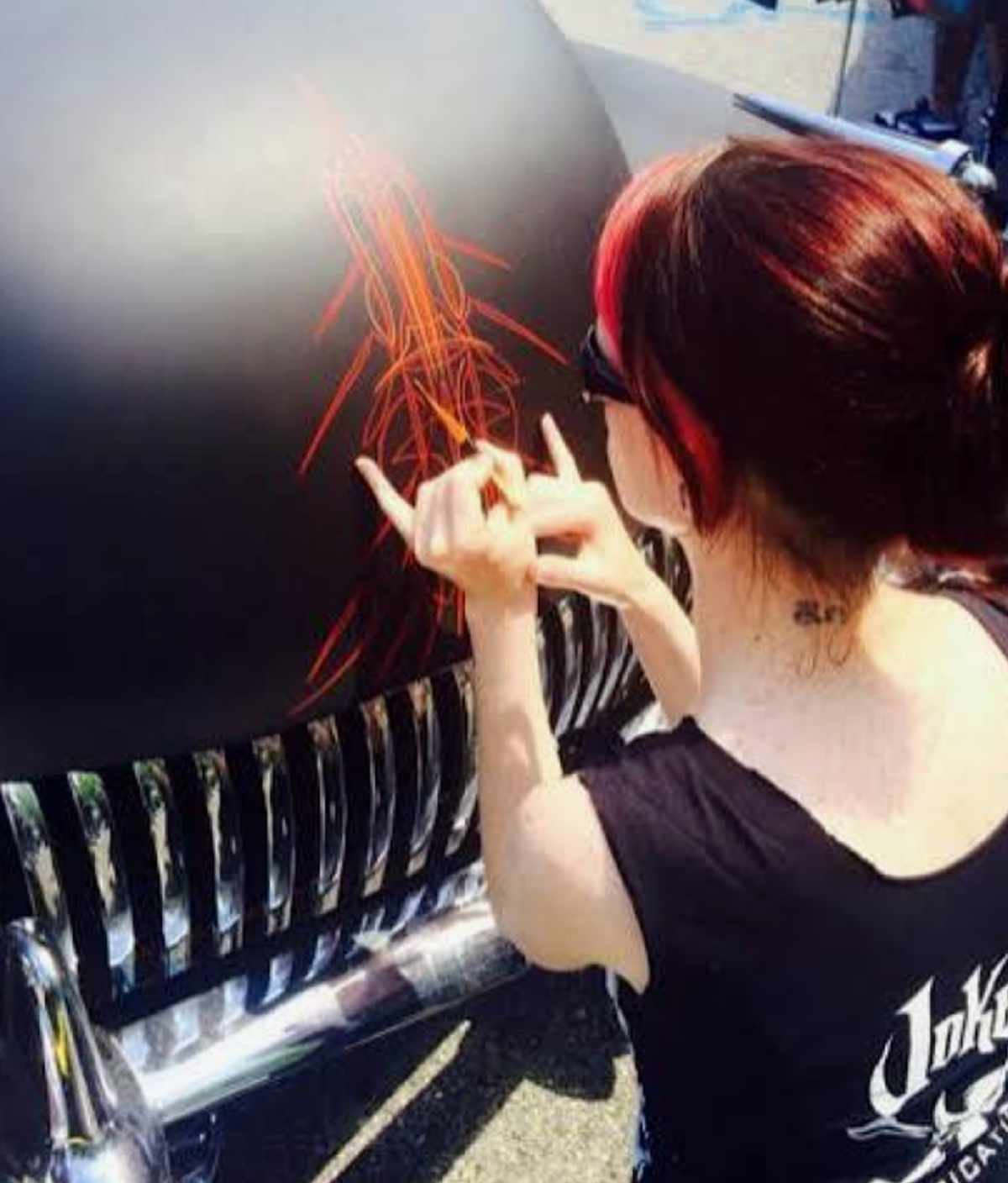 Hot Rod Jen pinstriping a vehicle